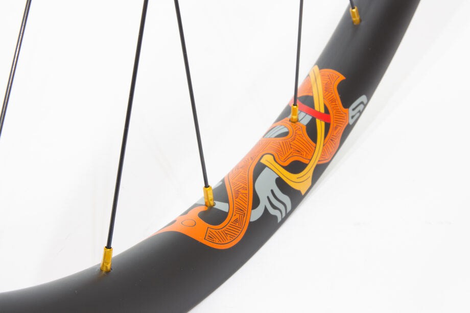 Karve carbon rim with orange water transfer decal and gold nipples