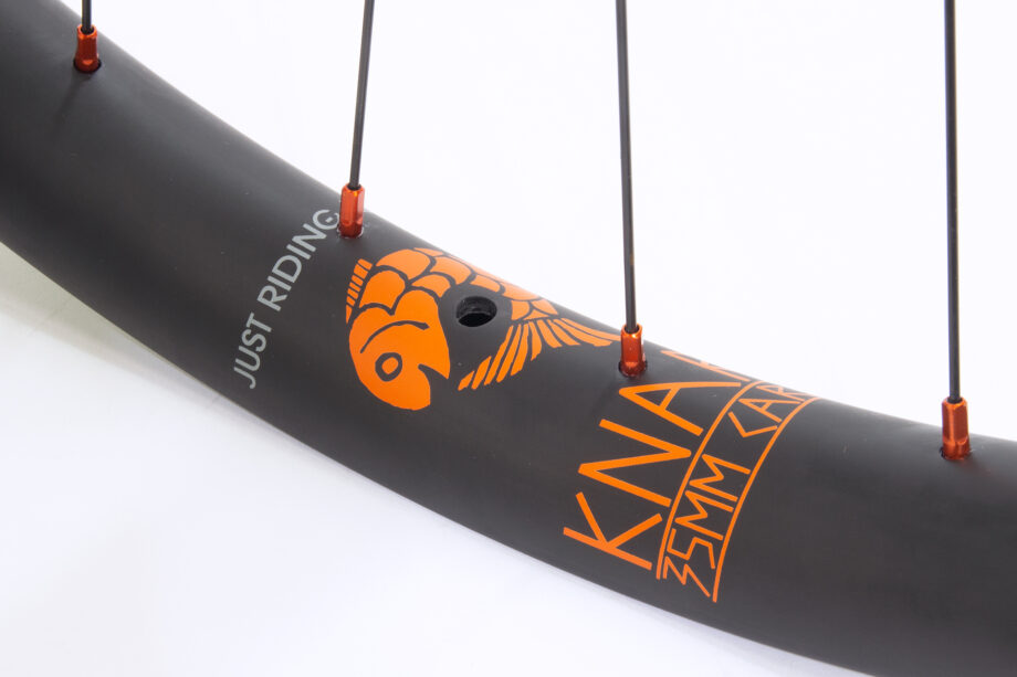 Knarr carbon rim with orange water transfer rim decals around valve hole